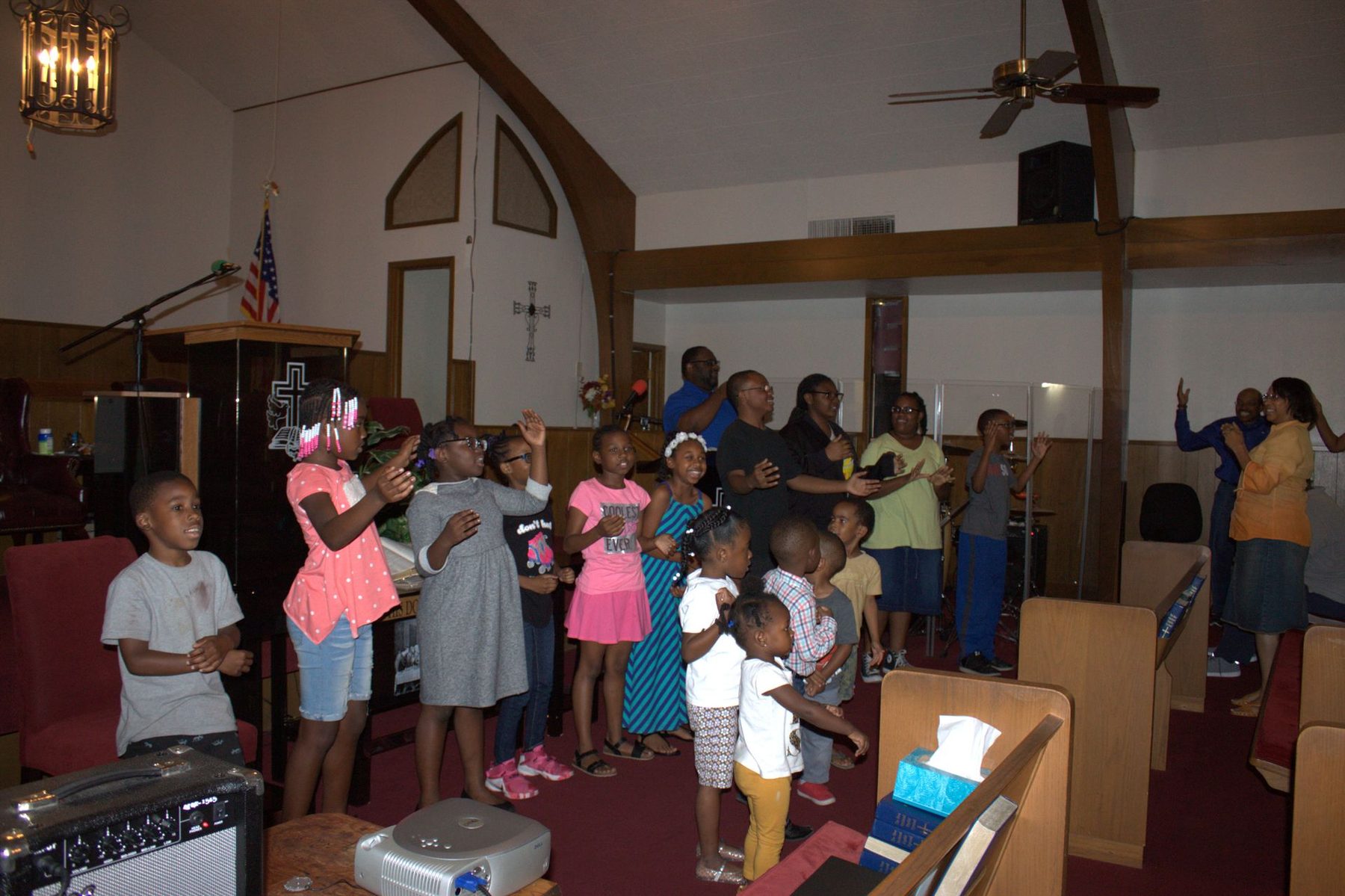 Children singing together at the front of the sanctuary